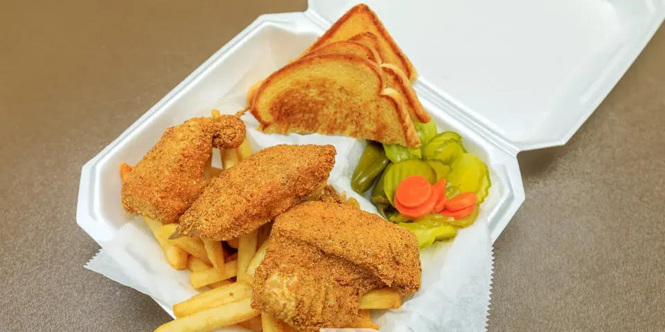 Golden fried catfish with fries, toast, pickles and peppers