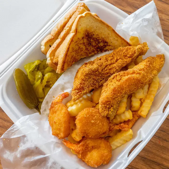 Fried fish and shrimp combo basket with fries and toast