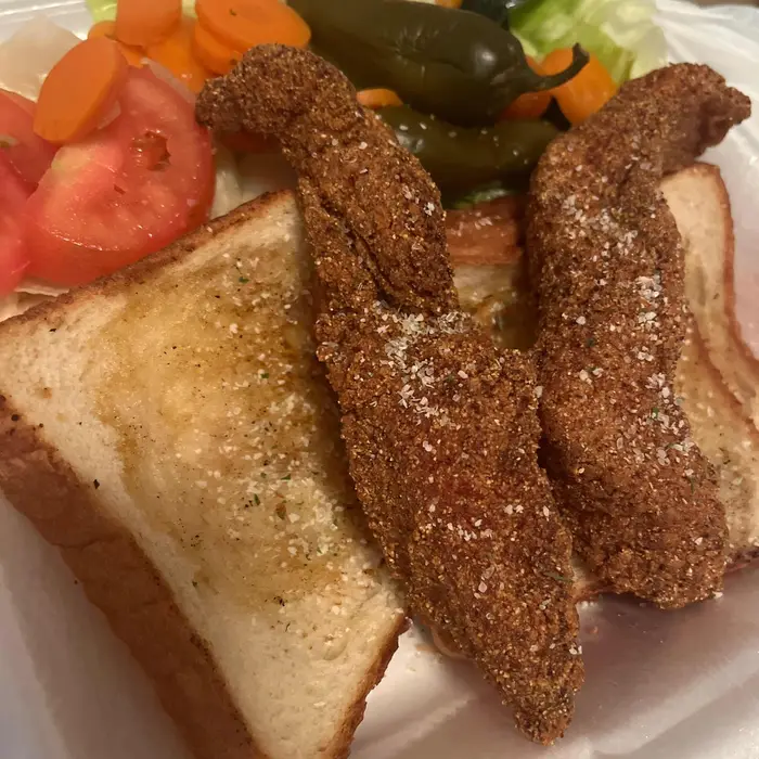 Fried catfish fillet sandwich with vegetables