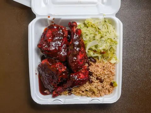 Oliver's Kitchen jerk chicken plate with rice and cabbage